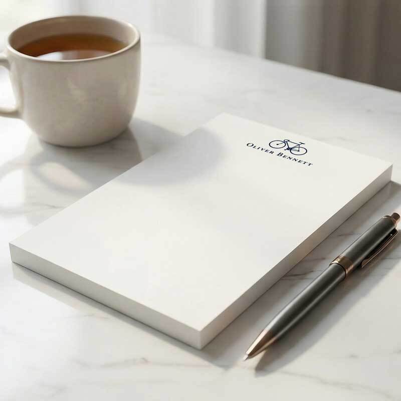Personalized notepad and pen beside a coffee mug on a calm marble desk &mdash; a quiet ritual for writing handwritten notes and staying connected
